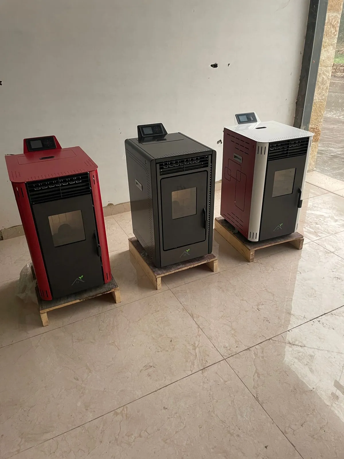 The 8KW pellet stove in its three colourways: red, graphite and white