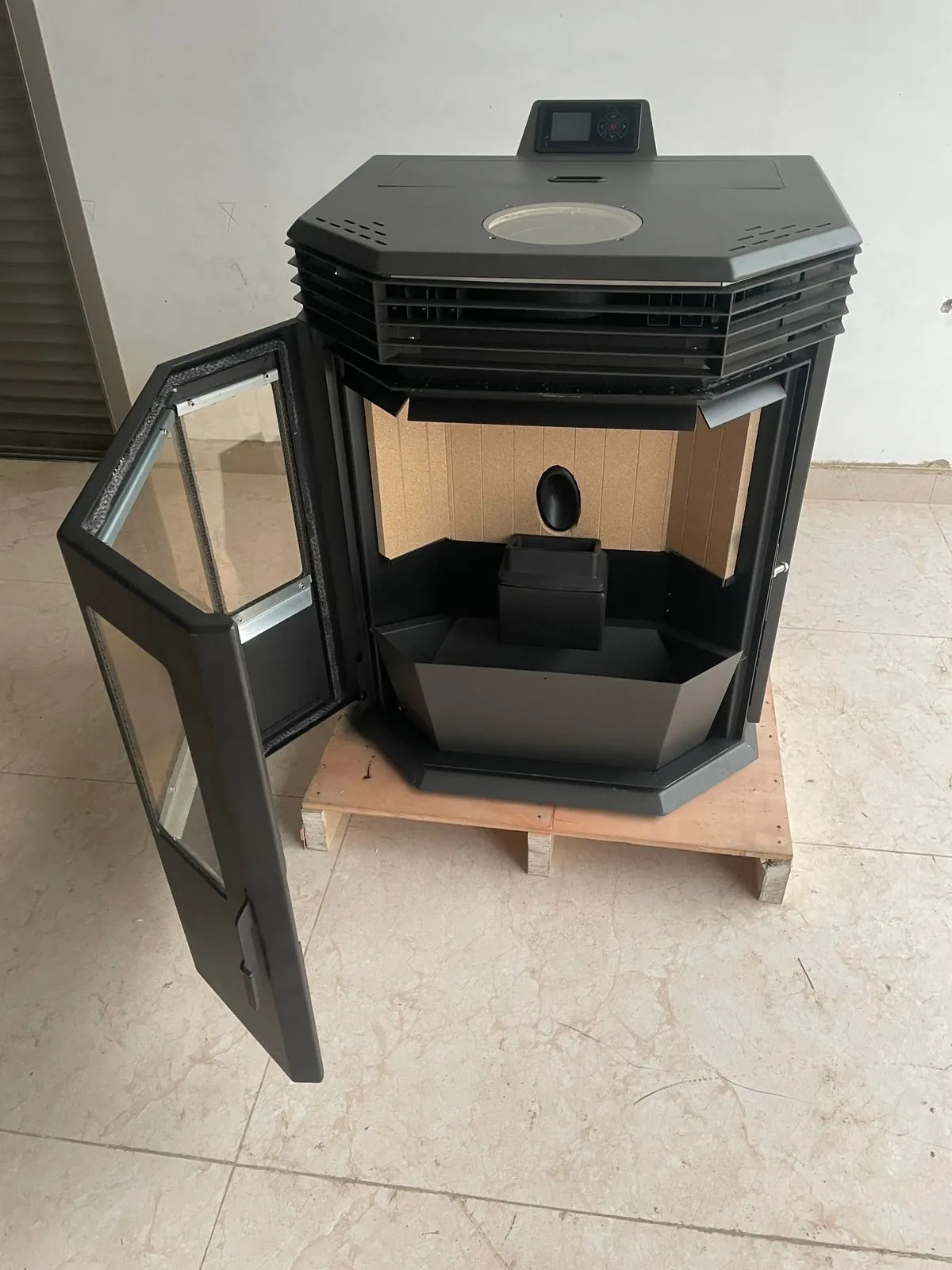 The 15KW with its panoramic door open: lined firebox and burn pot