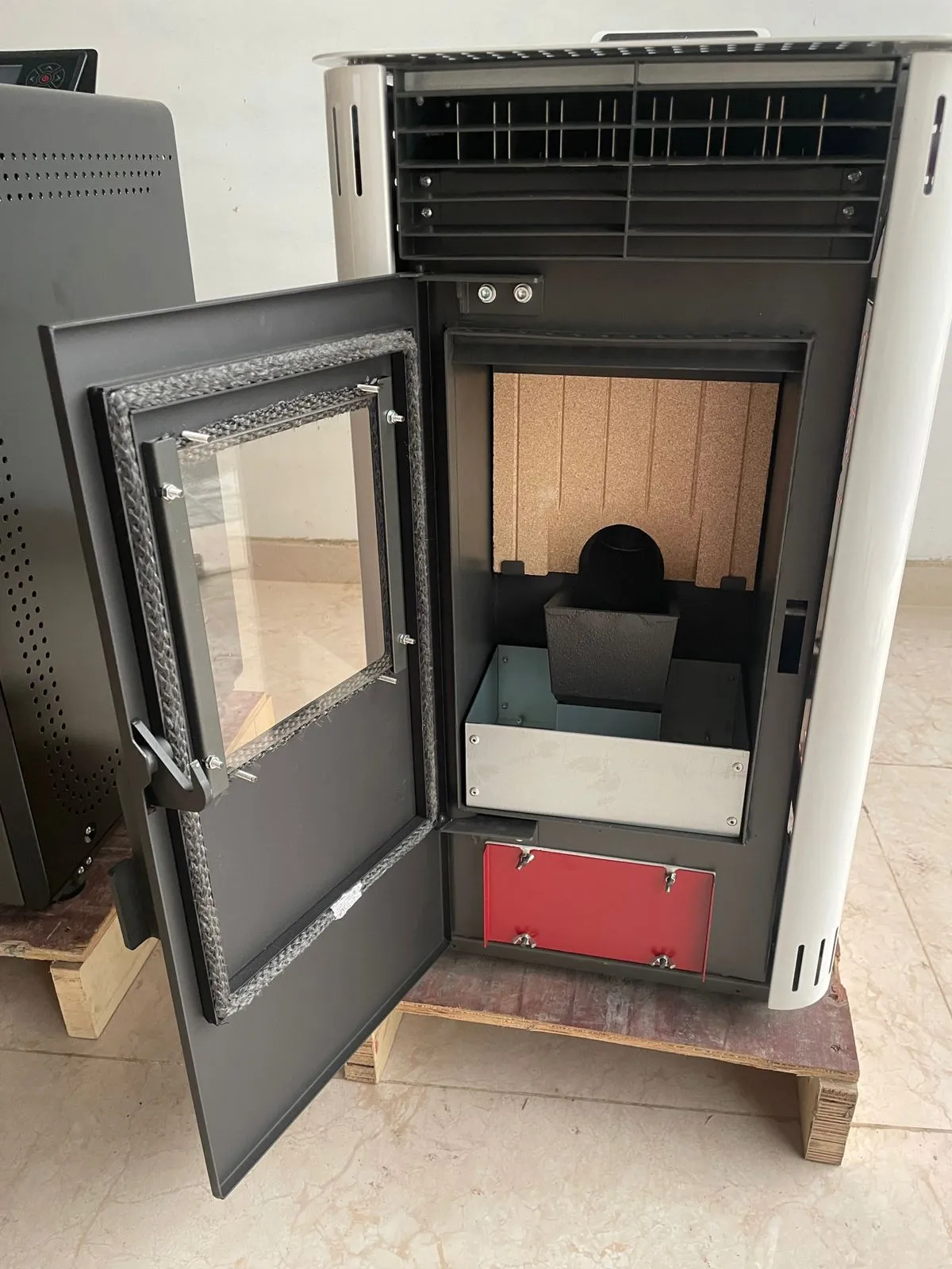 Inside the 8KW firebox: burn pot, ash tray and lined chamber