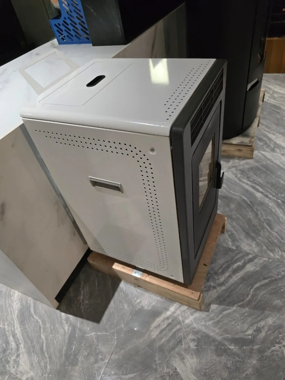 Cream pellet stove with a cooktop and black door, shown from above