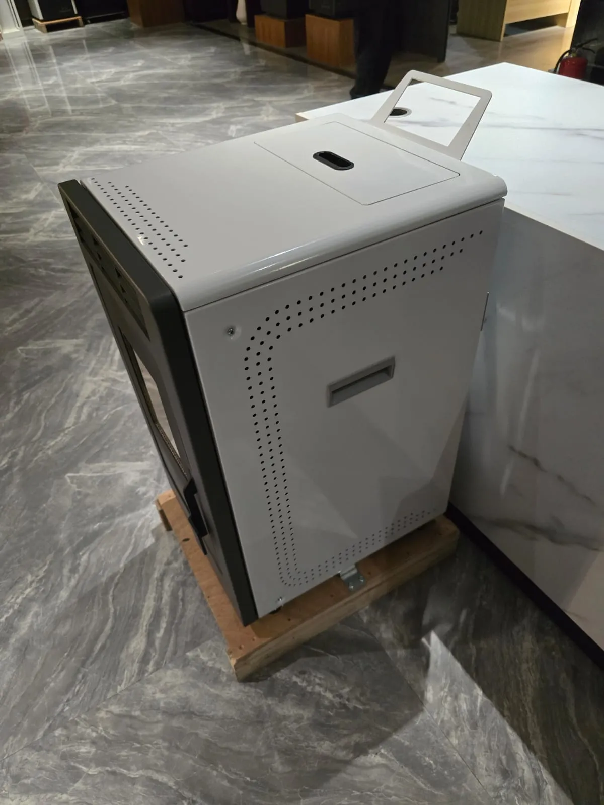 Cream pellet stove with a lift handle and black side door in a showroom